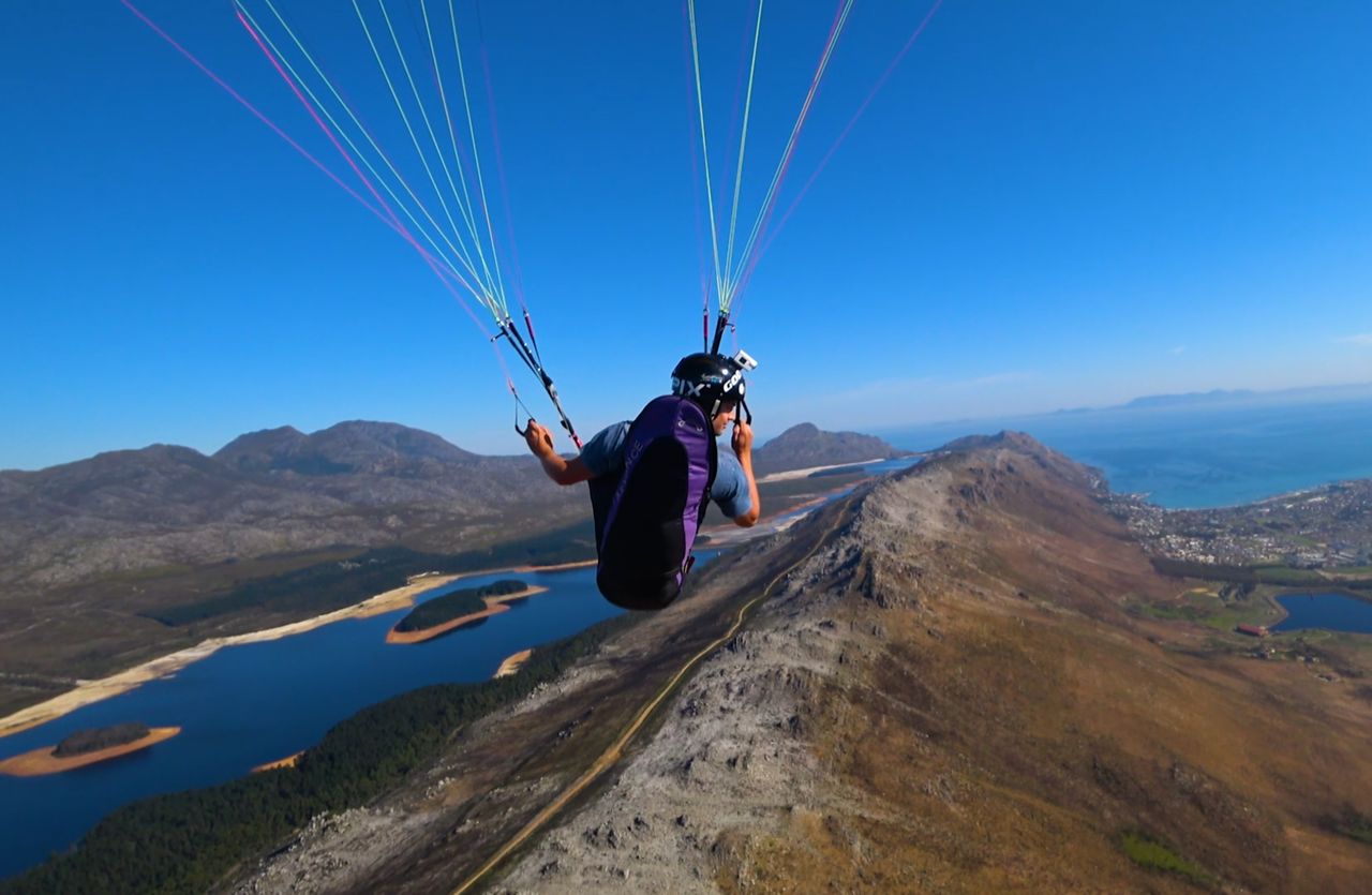 Paragliding over the mountains and dams near Cape Town